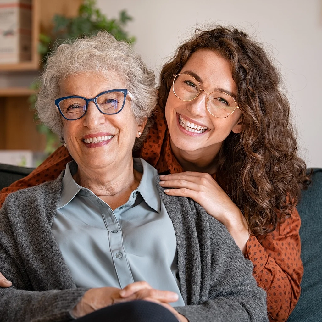 happy grandmother smiling and laughing with granddaughter